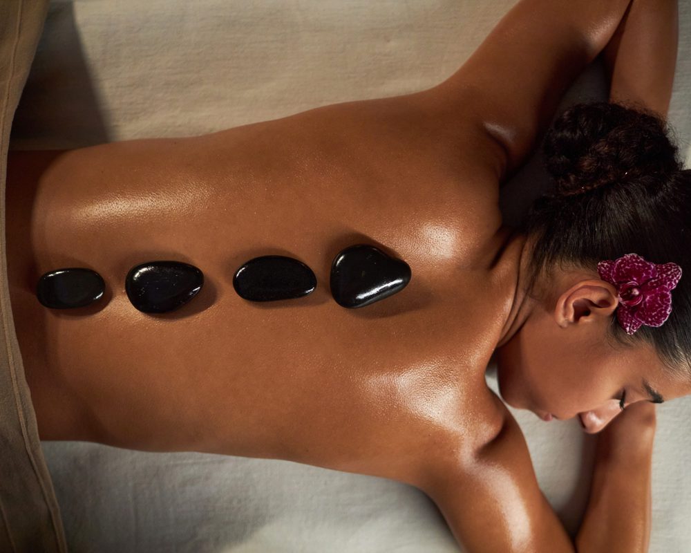 Hot stone massage treatment in progress
